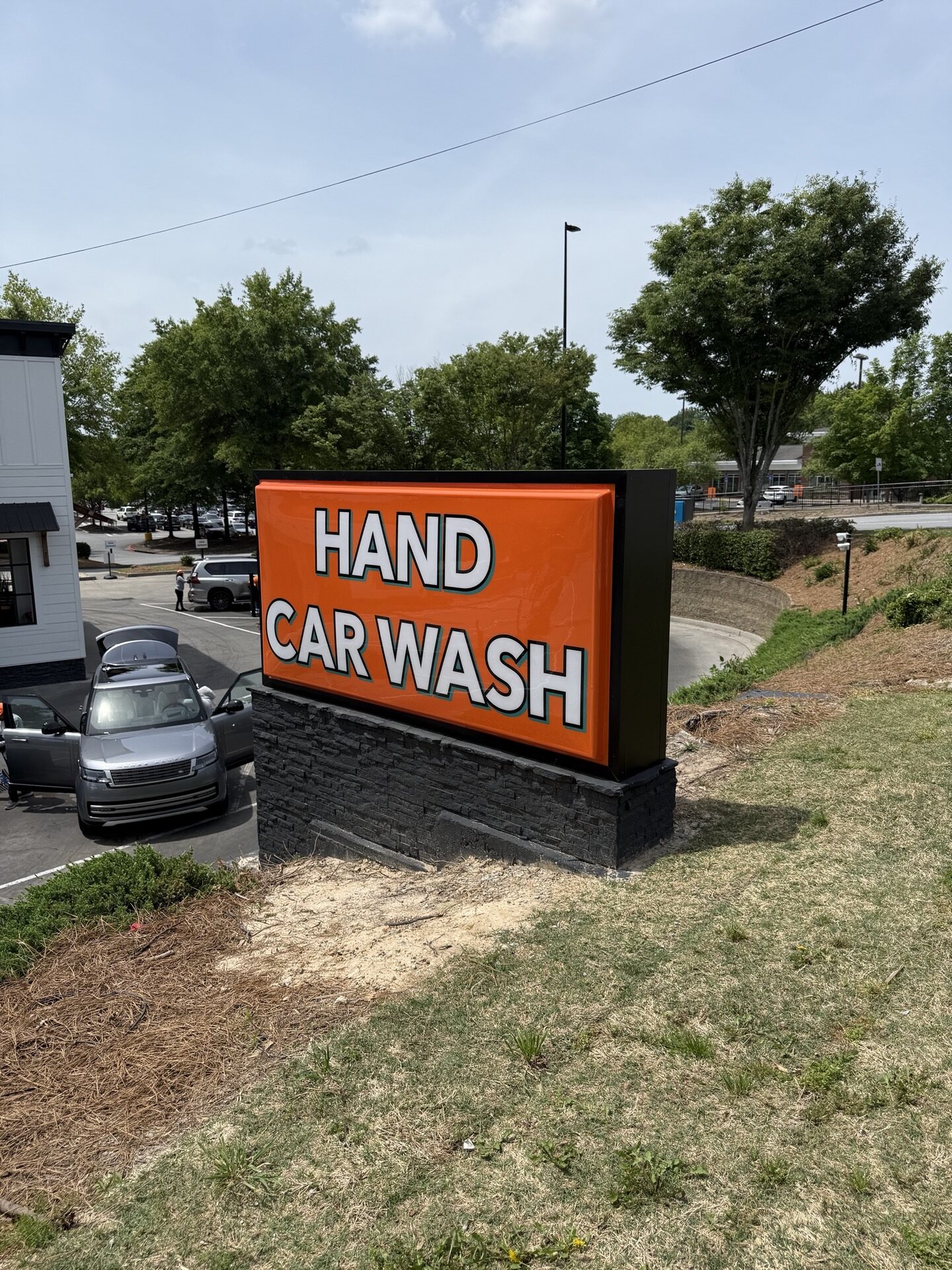 New monument sign for California Hand Wash in Milton, GA, featuring bold text and high-contrast design, installed along GA-9.