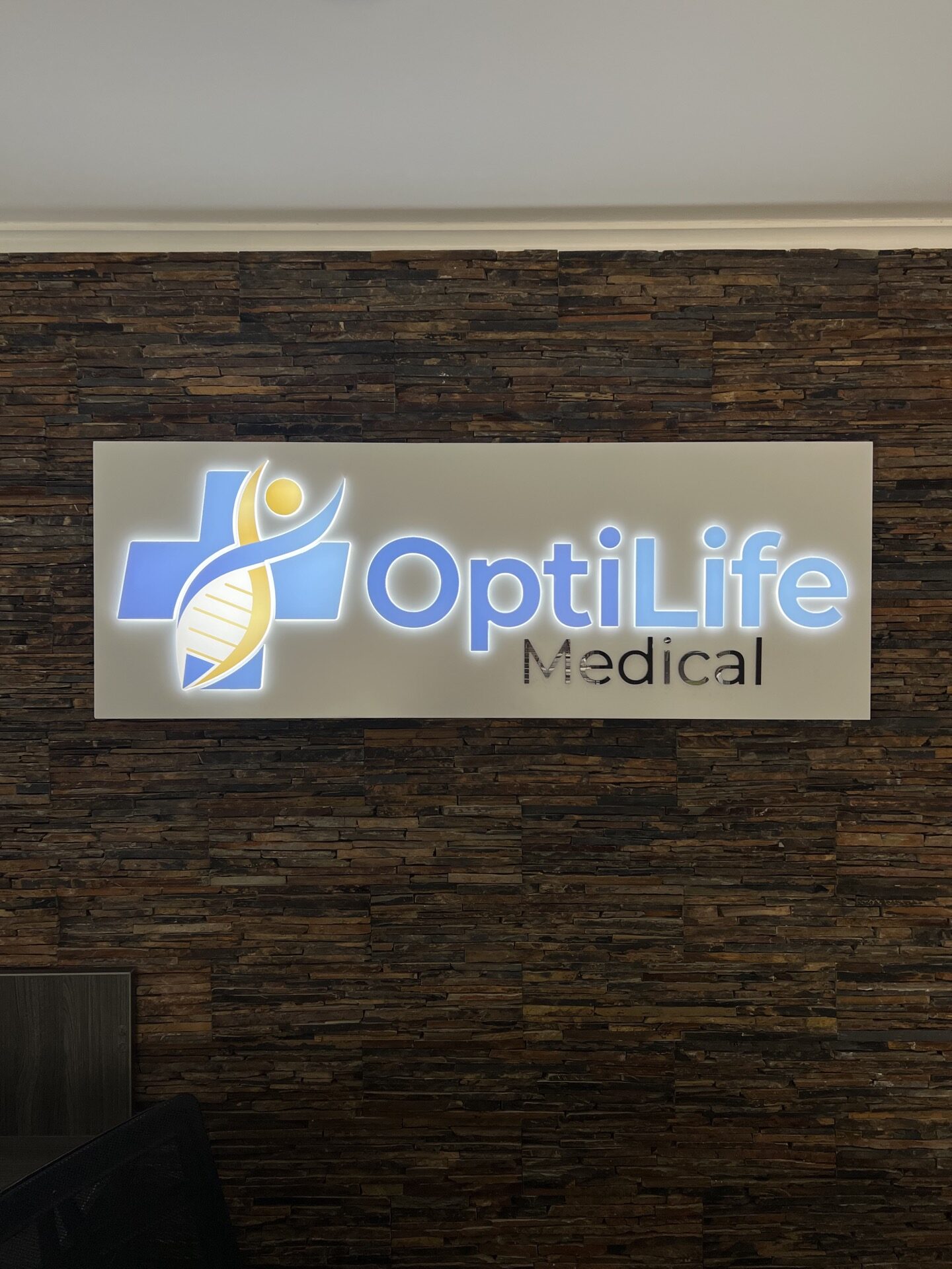 Close-up of custom LED lobby sign with translucent vinyl graphics, installed at OptiLife Medical in Roswell, Georgia.