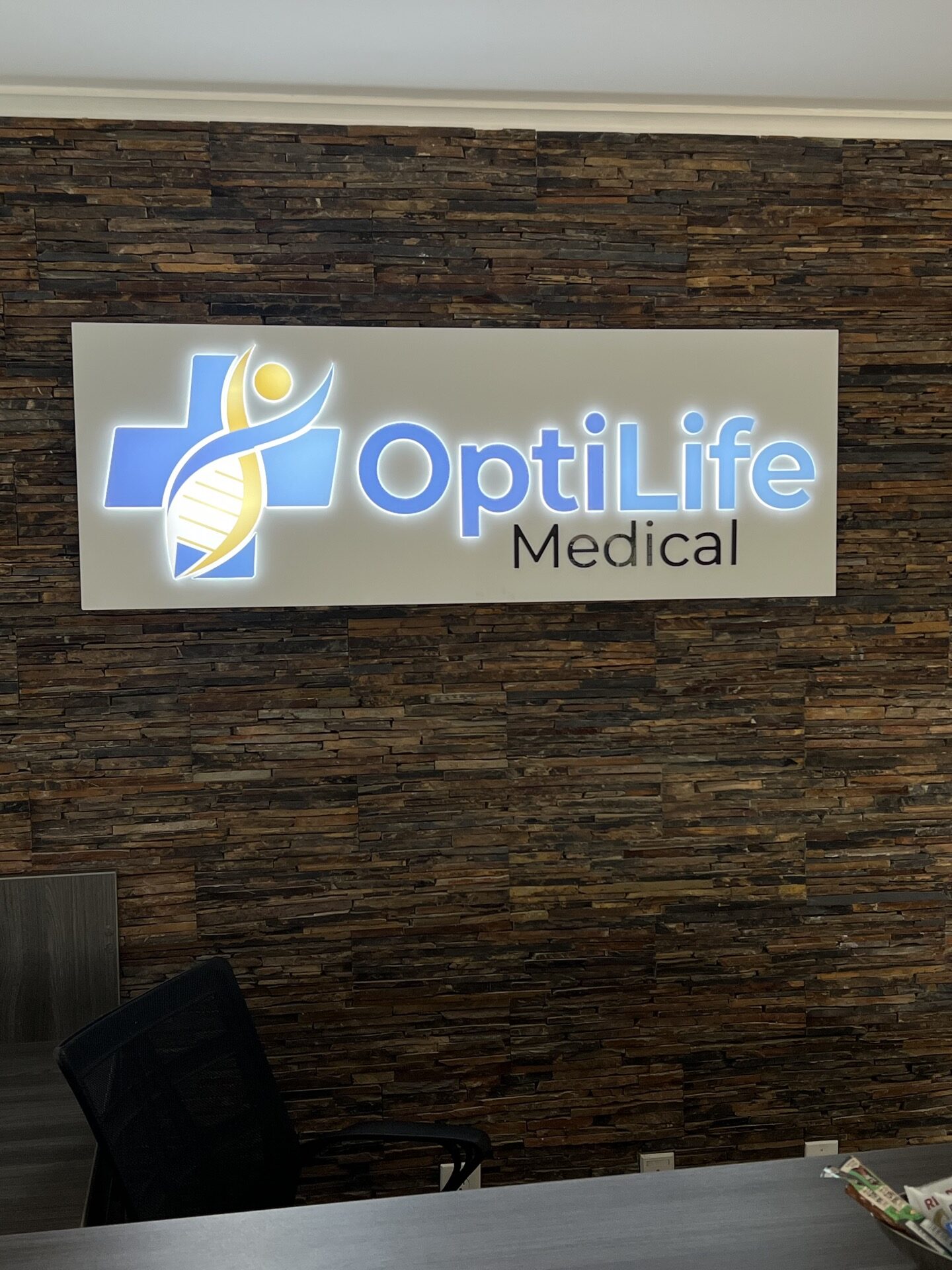 LED illuminated lobby sign for OptiLife Medical in Roswell, GA, featuring push-through acrylic letters and a clean, modern design.