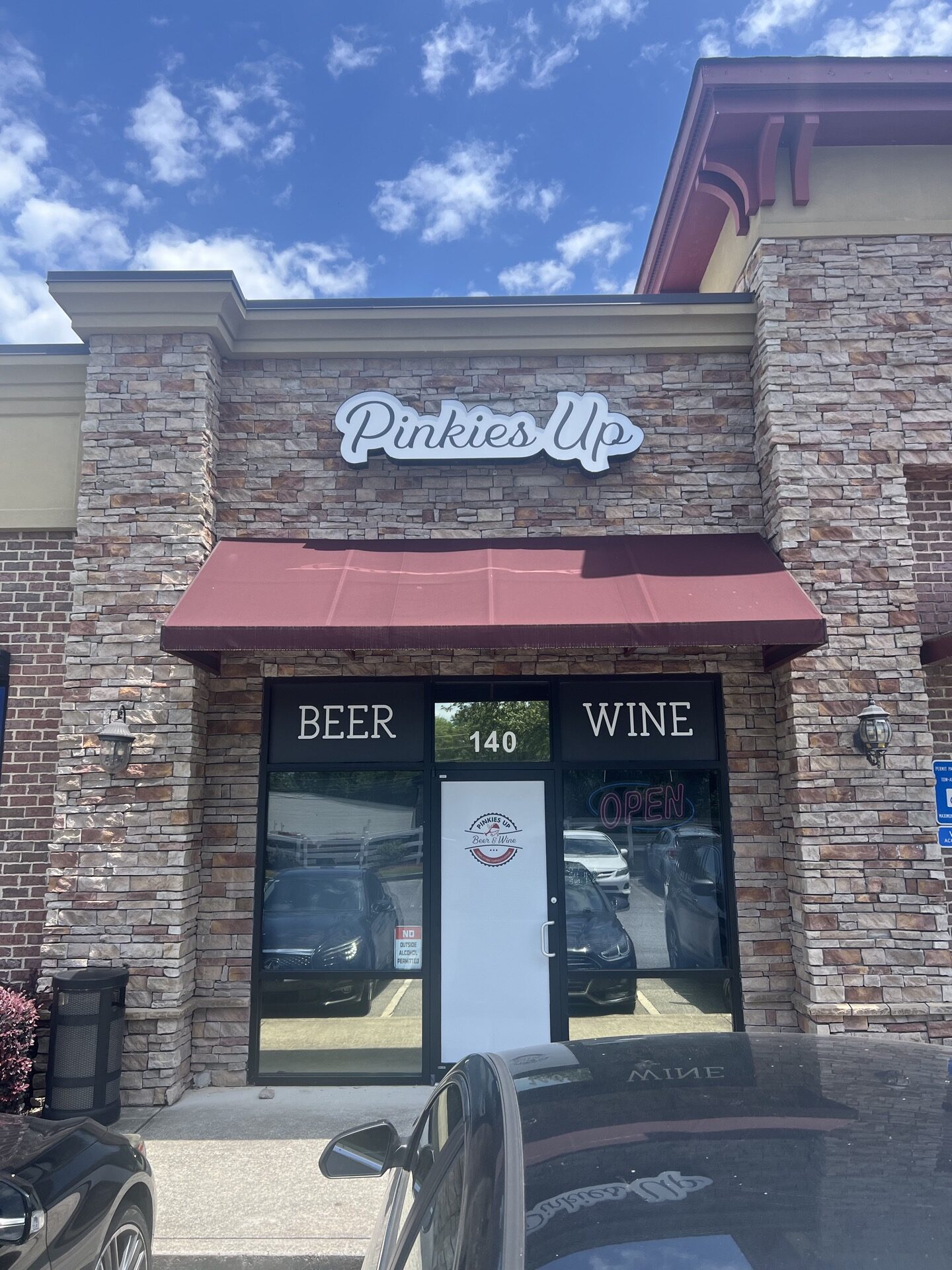 Custom cloud-style storefront sign for Pinkies Up Beer & Wine in Roswell, GA, featuring LED face-lit illumination and contoured vinyl graphics.