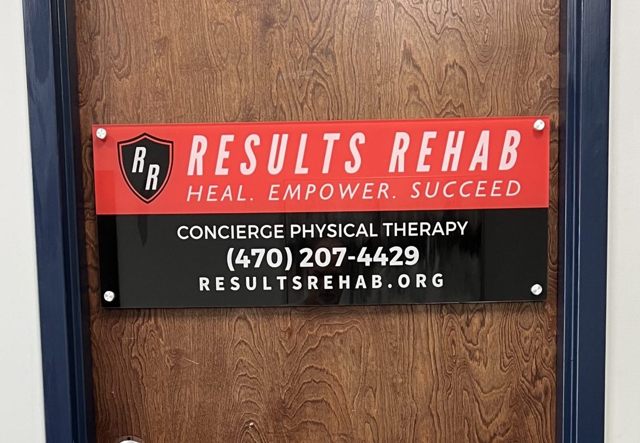 Acrylic office sign for Results Rehab featuring clean, modern lettering, mounted on an interior wall for a polished, professional look.